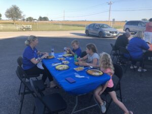 People eating at Team WTI open house