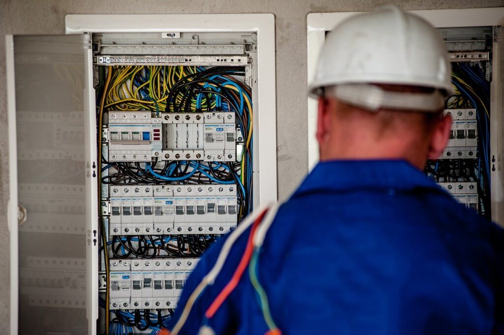 An electrician looking at a circuit box