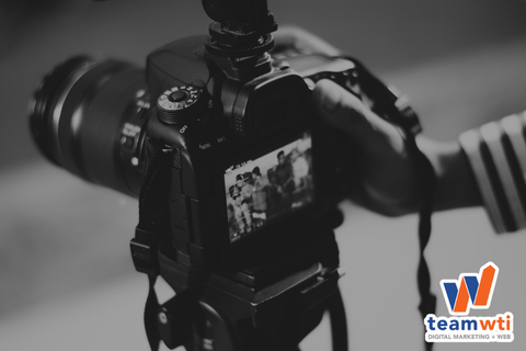 Image of a camera that photographers would use with the Team WTI logo. 