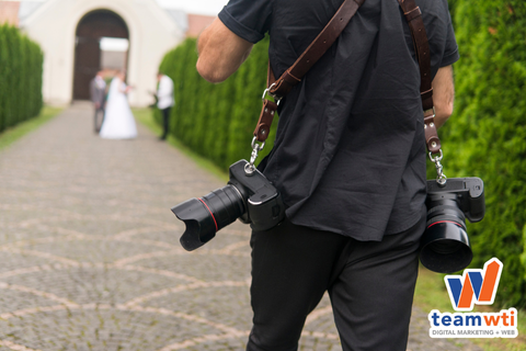 Image of a photographer with the Team WTI logo. 